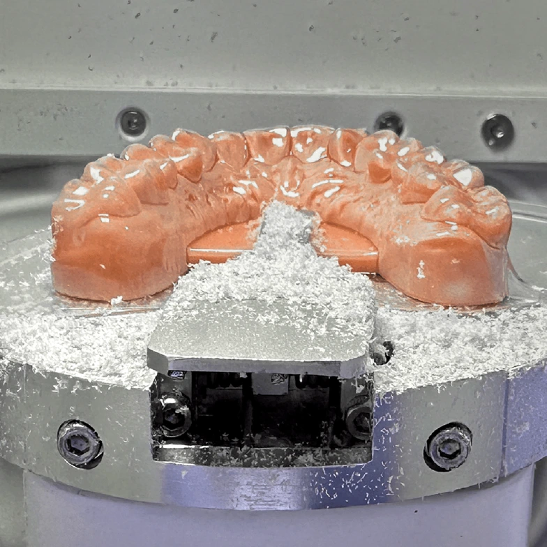 Thermoforming a clear aligner over a printed orthodontic model