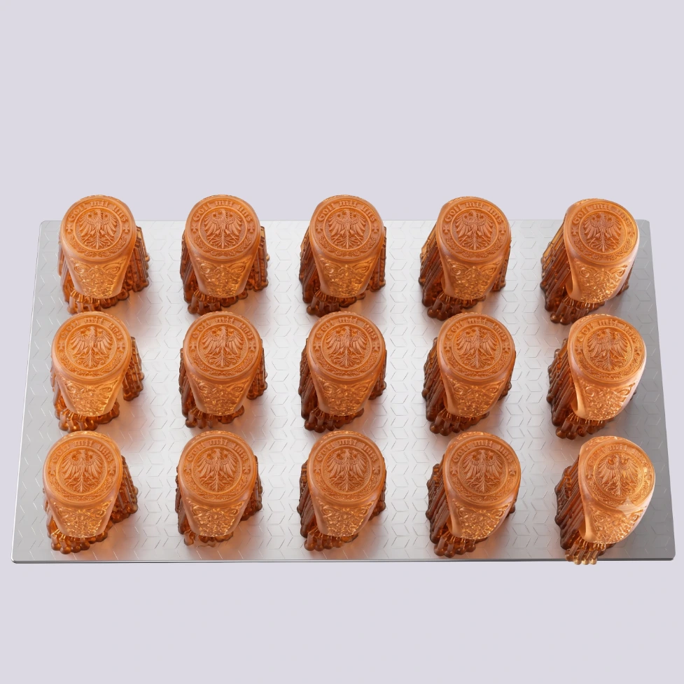 Batch of orange Rubber Mold Resin ring masters on a build platform