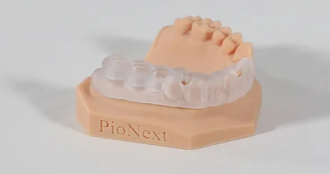 Clear surgical guide fitted on a printed dental model