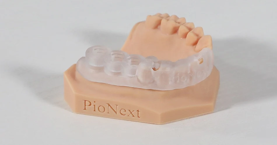 Clear surgical guide fitted on a printed dental model