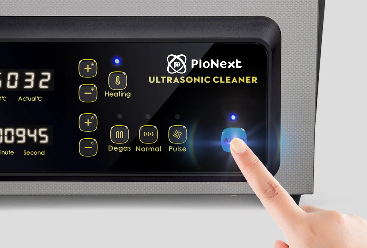 Finger operating the CD-X3 ultrasonic cleaner control panel